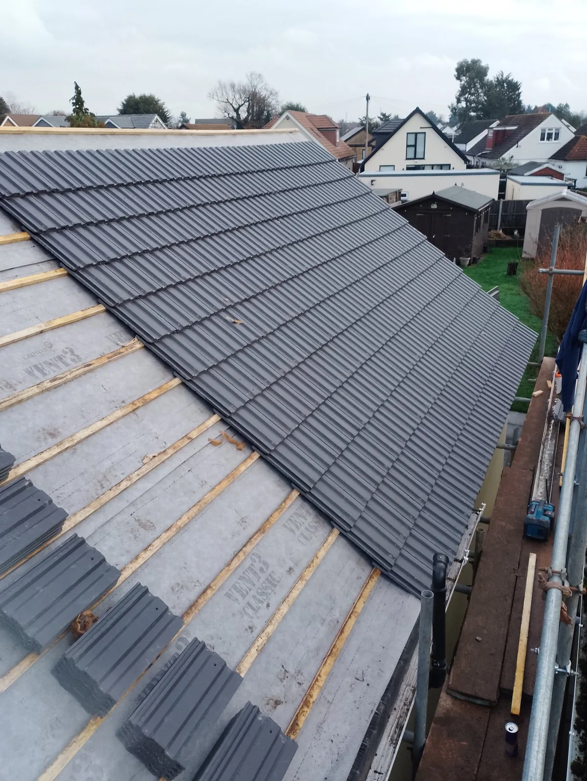 Re-roof in progress with new breathable membrane, battens and grey interlocking tiles