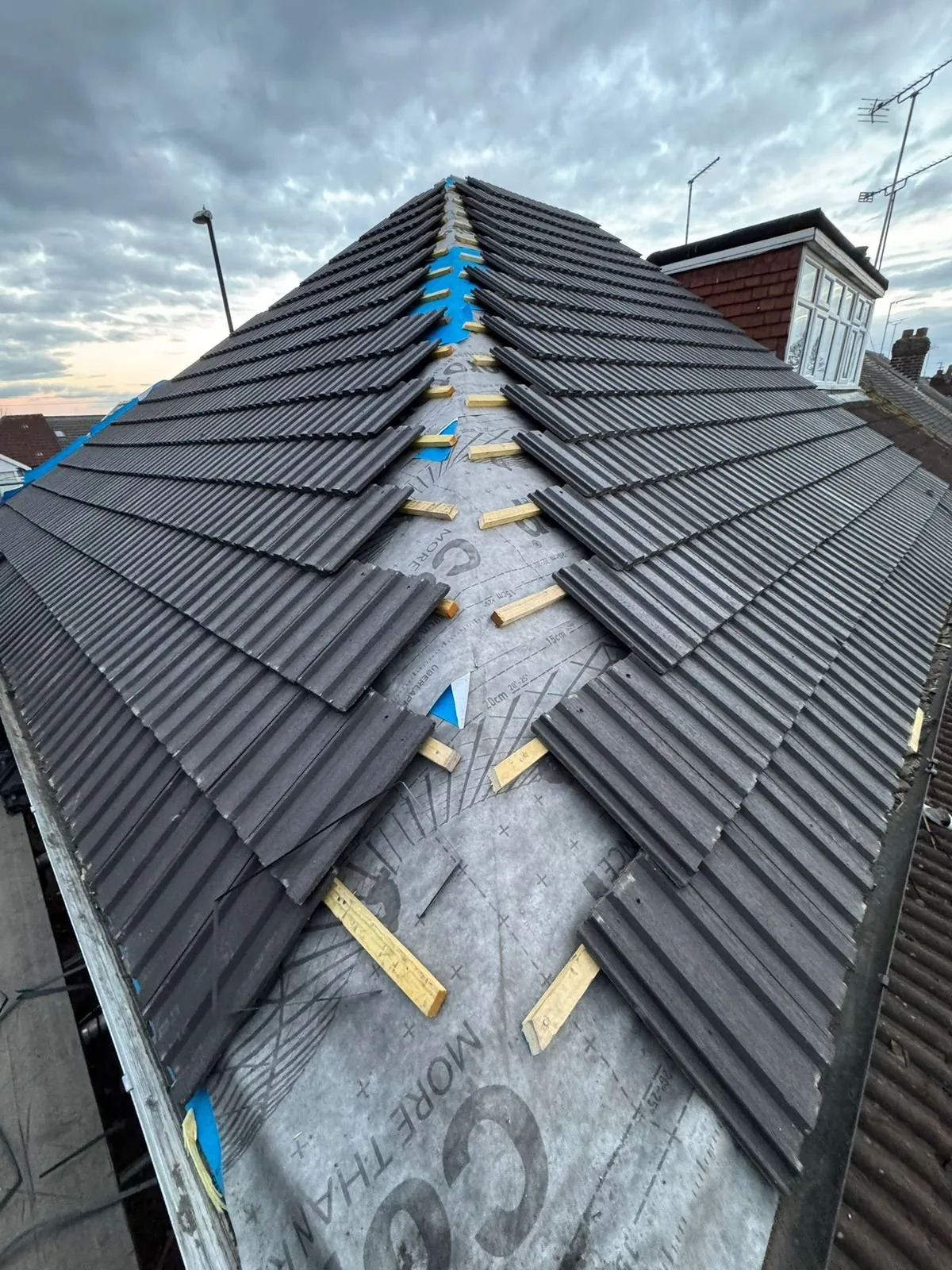 Roof hip being re-tiled over new breathable membrane and timber battens