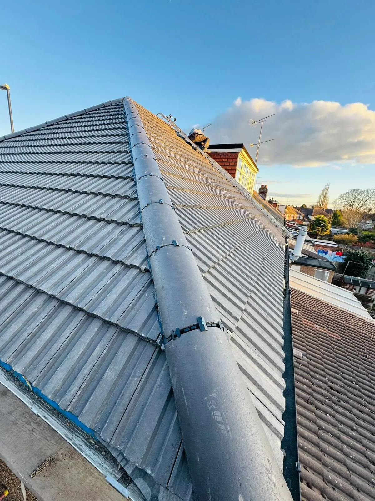 Grey concrete tiled roof completed with a dry-fix ridge system
